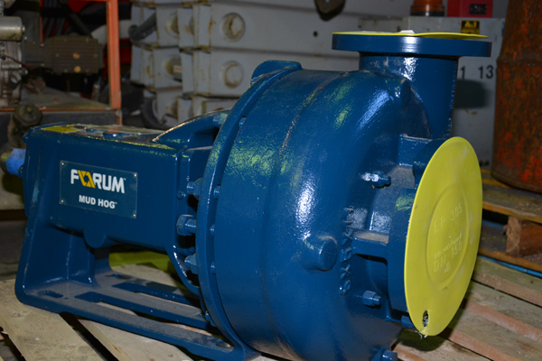 A heavy blue and yellow Forum mud pump now at JC Industries in Nisku