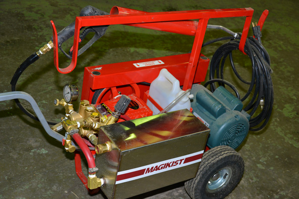 A bright red Magikist wheeled pressure washer sold by Nisku's JC Industries
